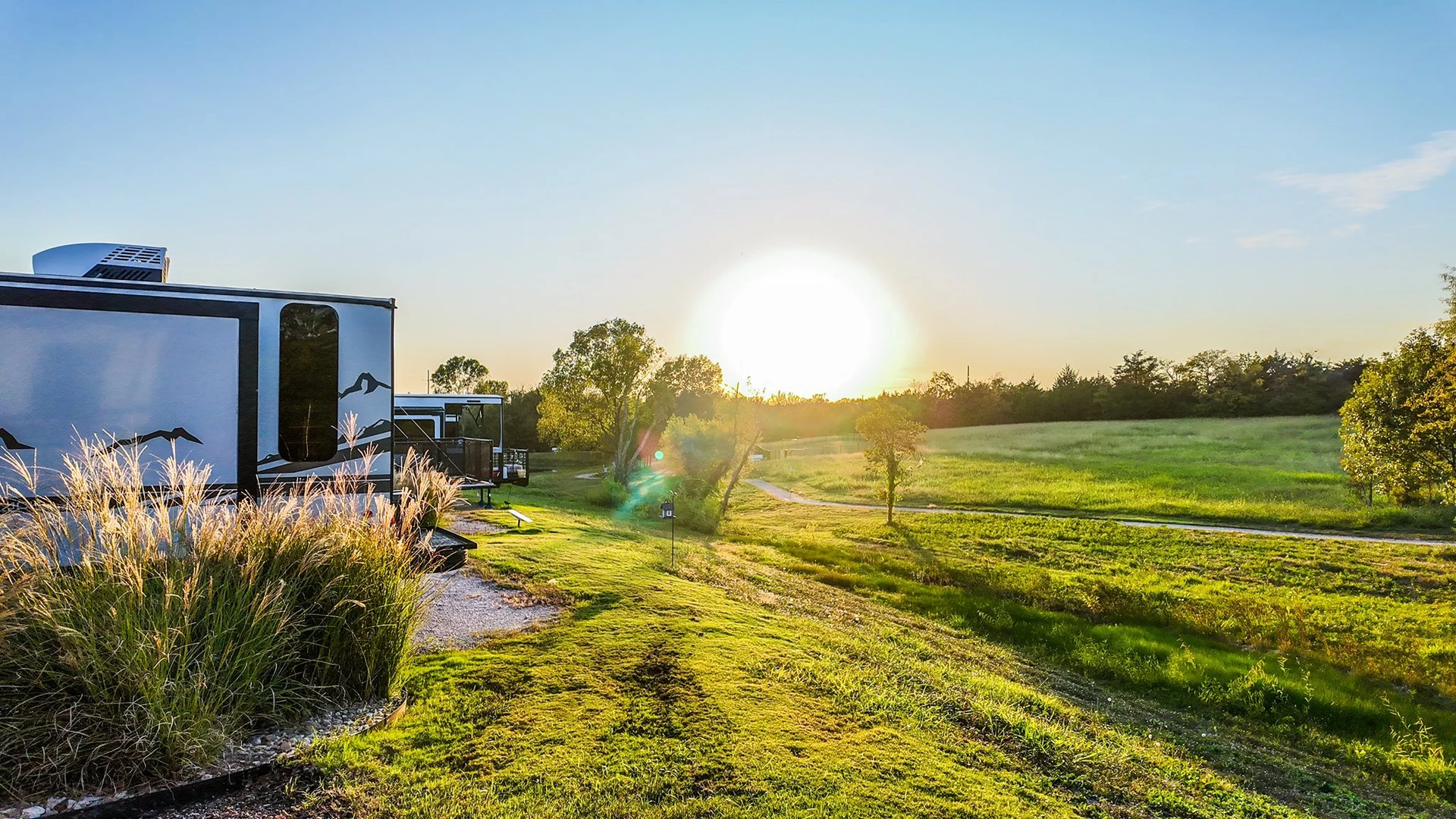 Sunset over fields and treelines around the park — peaceful country views that invite you to linger at Sugar Hill.